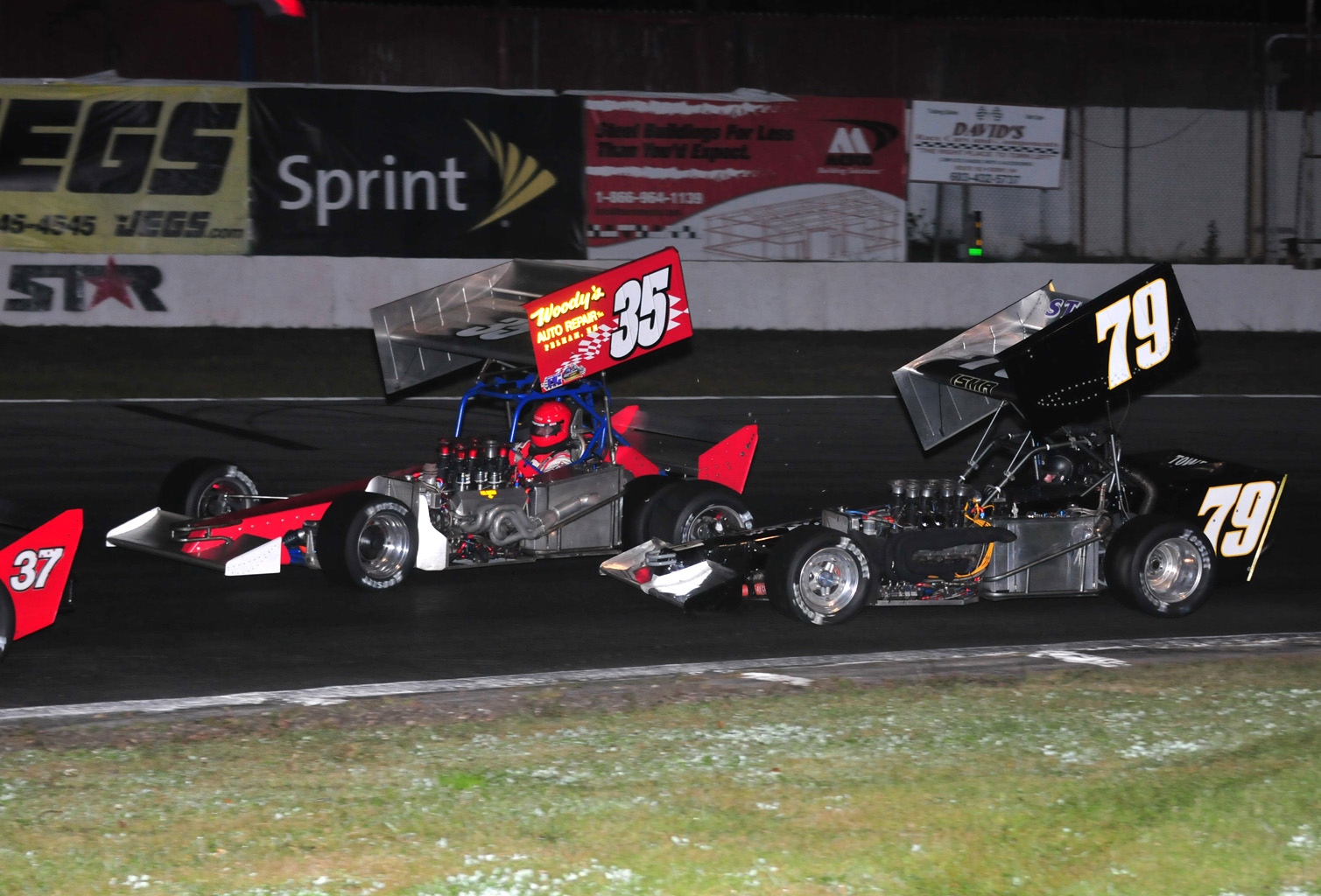 Some real tight racing for a podium finish between Rob Summers 35 and Jon McKennedy. McKennedy would get the podium with a third place finish. Summers was fourth. - Photo By Jim Feeney